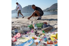 Image Study researchers collecting plastic waste at the beach.